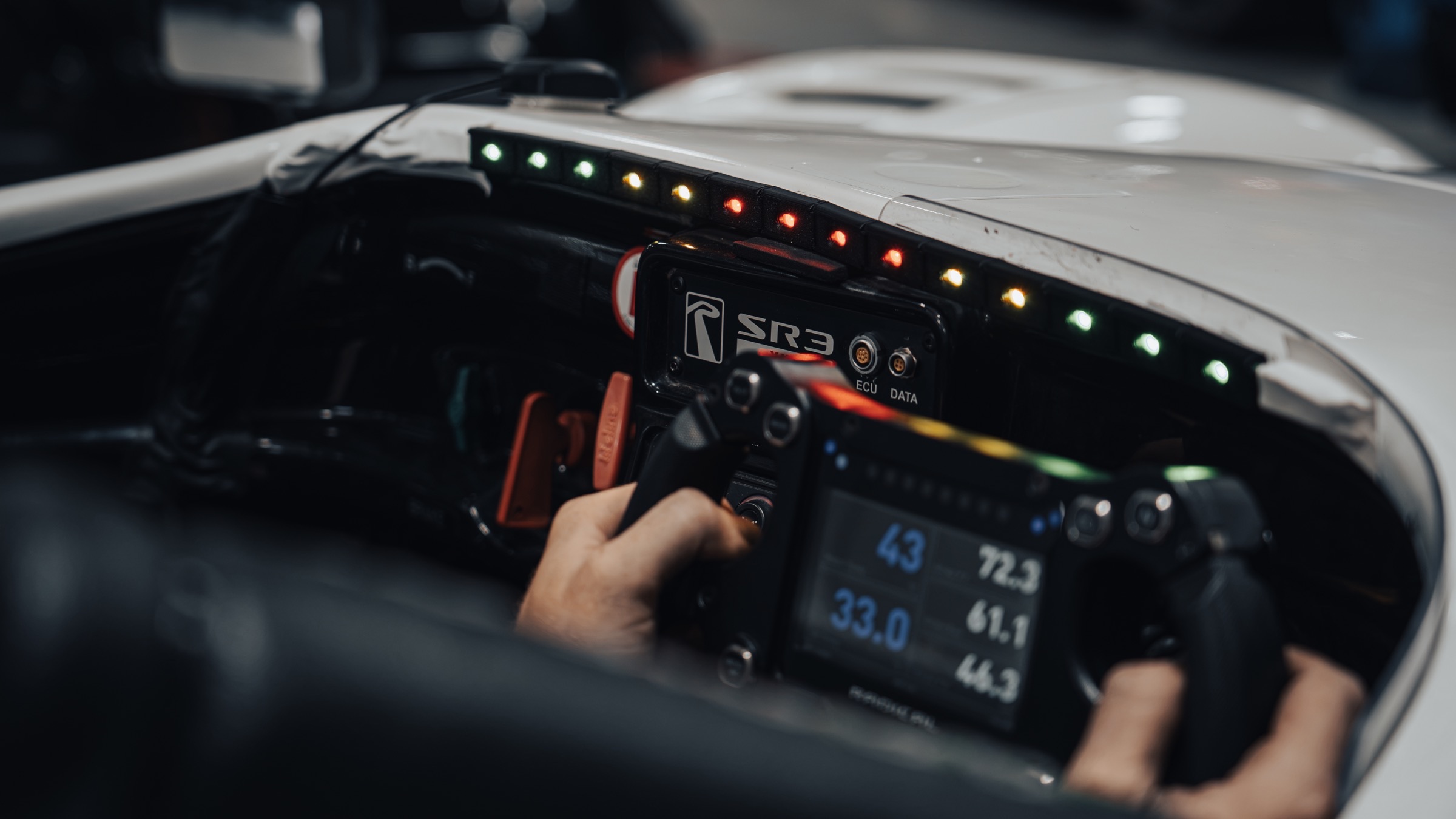 Brake Buddy LED feedback bar installed above the dashboard of a Radical SR3 race car